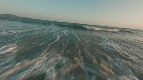 Extreme Low Angle Shot of Foamy Ocean Waves Rushing Towards Beach Shoreline Stock Footage 319295114