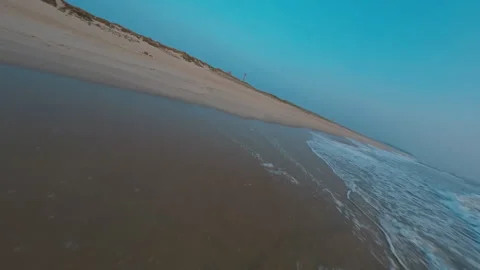Extreme Low FPV Drone Flight Along Shoreline Past Lifebuoy at Sunset, Portugal Stock Footage 327414060