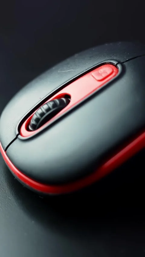 Extreme macro of a black and red computer mouse showing the textured scroll Stock Footage 329479893