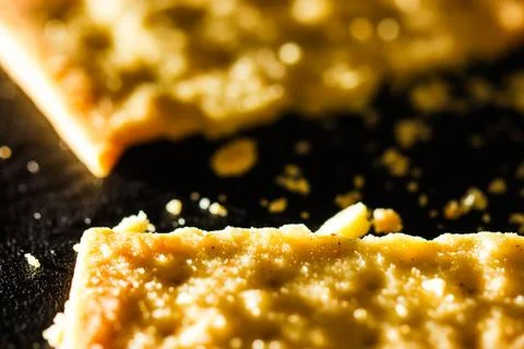 Extreme Macro of Broken Wheat Cracker Pieces with Golden Crumbs, Person Han.. Stock Photos