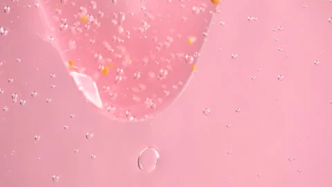 Extreme macro of bubbles in pink shower gel. Gel background with bubbles Stock Footage 275051175