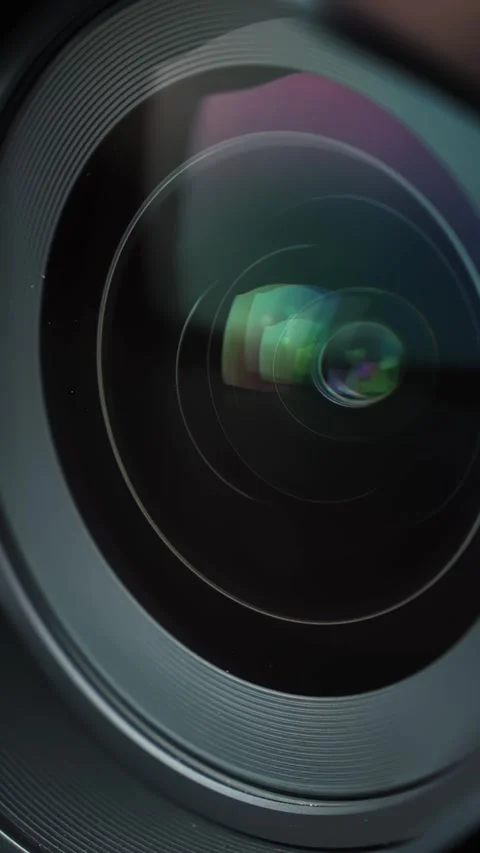 Extreme macro of a camera lens as aperture blades open, revealing colorful Stock Footage 329479952