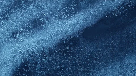 Extreme macro close-up of cracked blue melting ice texture in time lapse Stock Footage 334457379