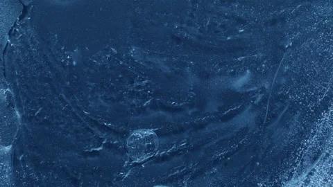Extreme macro close-up of cracked blue melting ice texture in time lapse Stock Footage 334457390