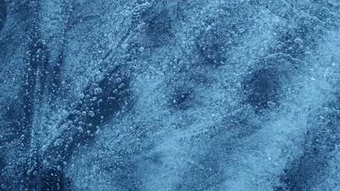 Extreme macro close-up of cracked blue melting ice texture in time lapse Stock Footage 334457415