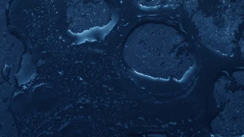 Extreme macro close-up of cracked blue melting ice texture in time lapse Stock Footage 334457416