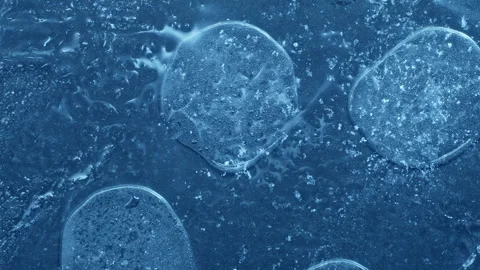 Extreme macro close-up of cracked blue melting ice texture in time lapse Stock Footage 334457856