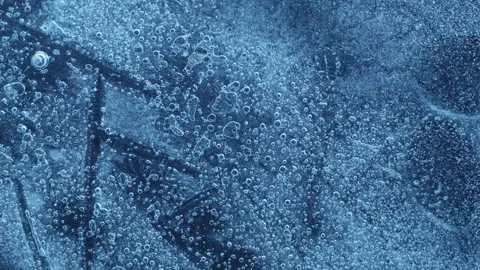 Extreme macro close-up of cracked blue melting ice texture in time lapse Stock Footage 334457865