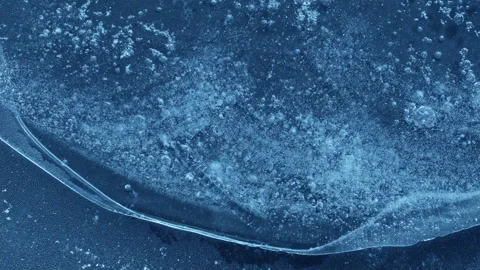 Extreme macro close-up of cracked blue melting ice texture in time lapse Stock Footage 334457868