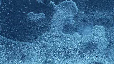Extreme macro close-up of cracked blue melting ice texture in time lapse Stock Footage 334457895