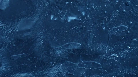 Extreme macro close-up of cracked blue melting ice texture in time lapse Stock Footage 334458367