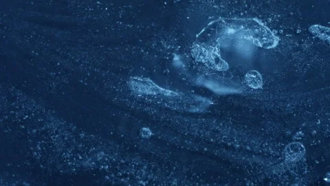 Extreme macro close-up of cracked blue melting ice texture in time lapse Stock Footage 334458385