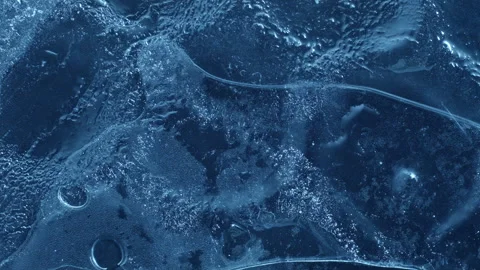 Extreme macro close-up of cracked blue melting ice texture in time lapse Stock Footage 334458746