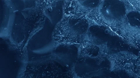 Extreme macro close-up of cracked blue melting ice texture in time lapse Stock Footage 334458747