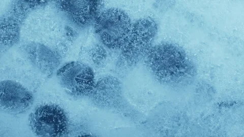 Extreme macro close-up of cracked blue melting ice texture in time lapse Stock Footage 334458748