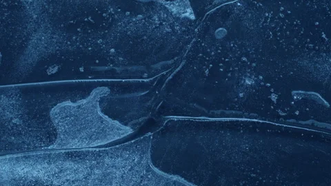 Extreme macro close-up of cracked blue melting ice texture in time lapse Stock Footage 334458758