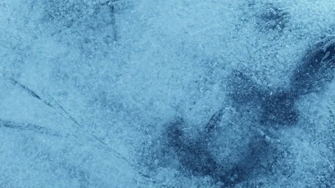 Extreme macro close-up of cracked blue melting ice texture in time lapse Stock Footage 334458766