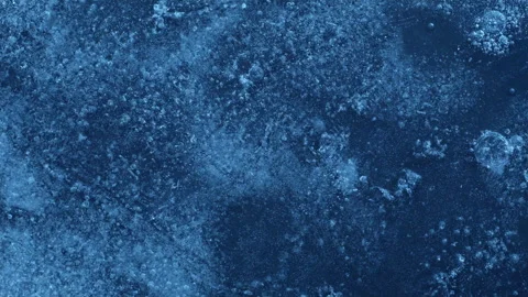 Extreme macro close-up of cracked blue melting ice texture in time lapse Stock Footage 334458903