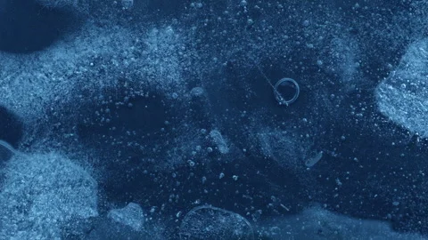 Extreme macro close-up of cracked blue melting ice texture in time lapse Stock Footage 334458905