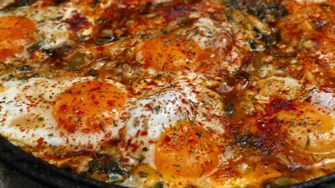 Extreme macro close up of delicious fried eggs with spices bubbling Stock Footage 337203636