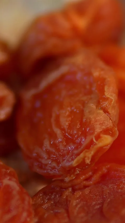 An extreme macro close-up of dried apricot pieces Stock Footage 328804314
