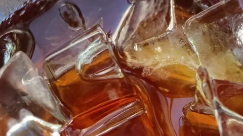 Extreme Macro Close-Up of Large Clear Ice Cubes in Amber Whiskey Stock Footage 344746837