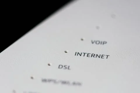 Extreme macro close up of a modem router, focusing on the word "Internet". Stock Photos