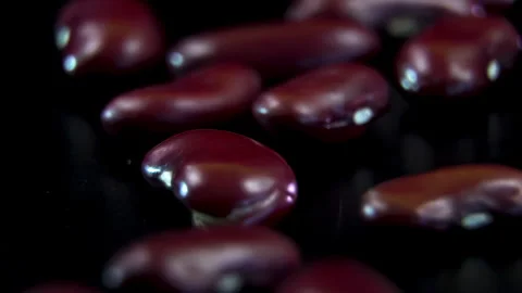 Extreme macro close up of raw red kidney beans heap rotating on dark background Stock Footage 338126911