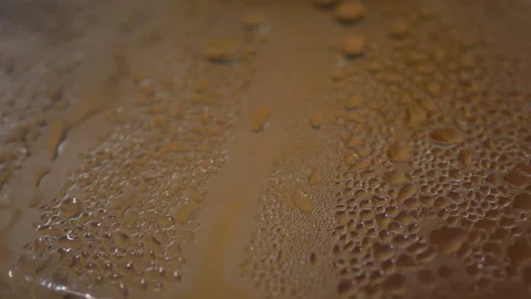 Extreme macro close-up of water droplets condensing on a smooth Stock Footage 329116867
