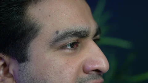 Extreme macro crop of a young man profile face looking away during an interview Stock Footage 336043671