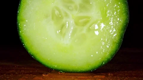 Extreme Macro Of Cucumber Slice Being Sprayed With Water Droplets Stock Footage 324239906