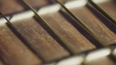 Extreme Macro Of Golden Guitar Strings Over Wooden Fretboard Stock Footage 328583069