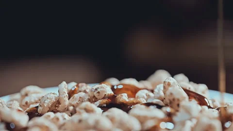 Extreme Macro of Golden Maple Syrup Pouring Over Crispy Puffed Cereal Stock Footage 341962711