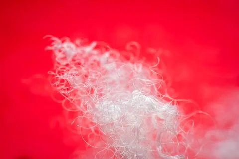 Extreme macro of polyester stable fiber on red background Stock Photos