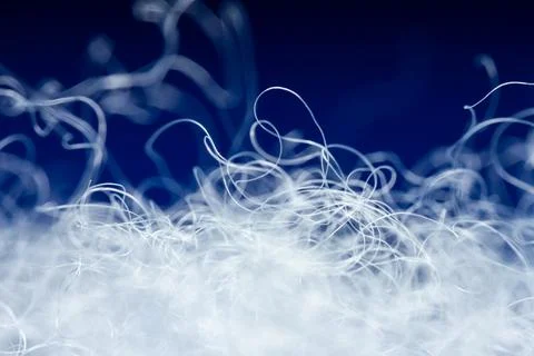 Extreme macro of polyester stable fiber on blue background Stock Photos