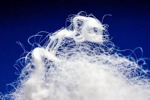 Extreme macro of polyester stable fiber on blue background Stock Photos