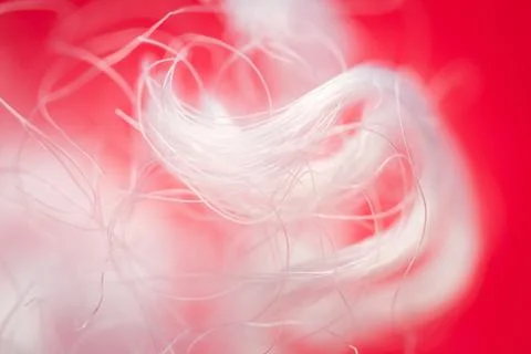 Extreme macro of polyester stable fiber on red background Stock Photos