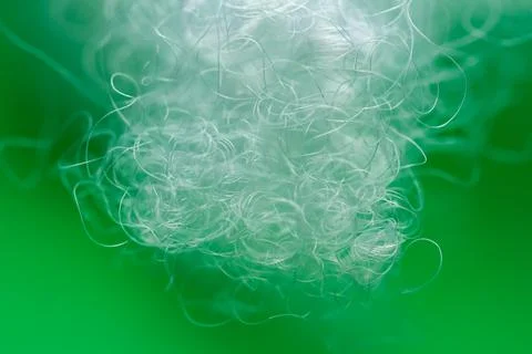 Extreme macro of polyester stable fiber on green background Stock Photos