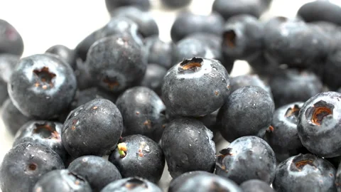 Extreme Macro Rotating Fresh Blueberries with Water Drops Texture 4K Stock Footage 320655849