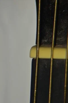 Extreme macro shot of instrument strings of acoustic guitar. 库存照片