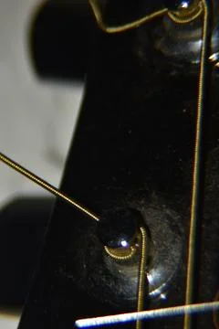Extreme macro shot of instrument strings of acoustic guitar. Photos