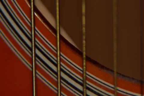 Extreme macro shot of instrument strings of acoustic guitar. Stock Photos