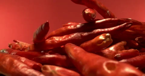 Extreme Macro Shot of Red Hot Chili Peppers Rotating Red Background Stock Footage 130966029