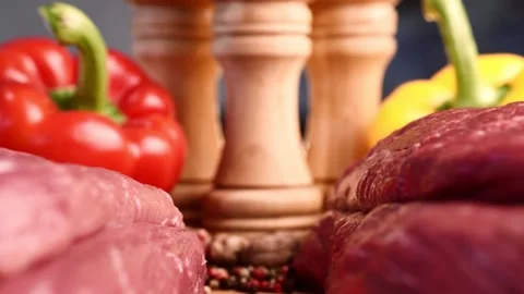 Extreme macro shot of slide between two raw beef fillets on wooden board with Stock Footage 156361591