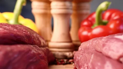 Extreme macro shot of slide between two raw beef fillets on wooden board with Stock Footage 157128580