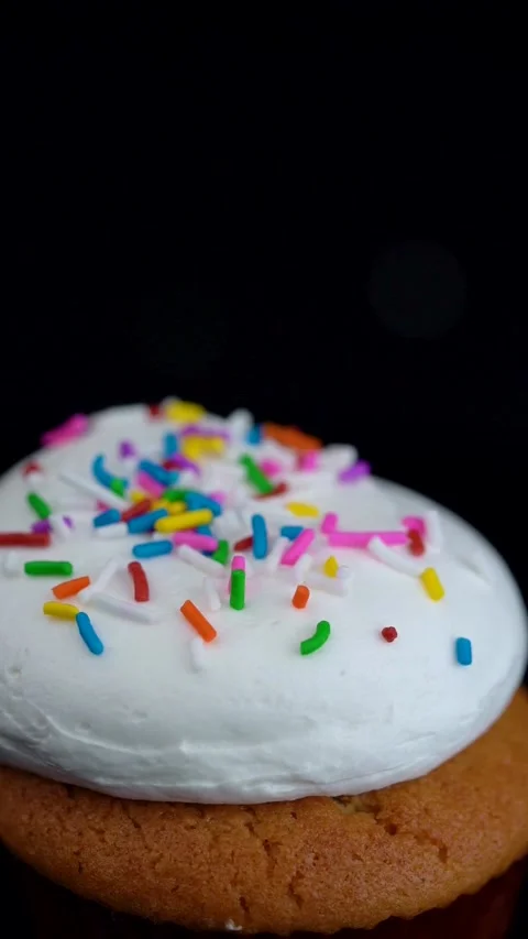 Extreme Macro Vanilla Cupcake with Rainbow Sprinkles Rotating Stock Footage 330516799