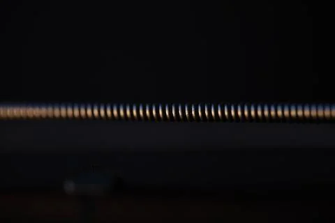 Extreme macro of a wound guitar string on dark background Stockfoto's