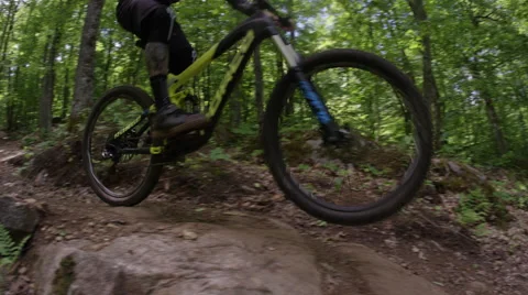 Extreme Mountain Biking - jumping an awesome feature on a dynamic trail Stock Footage