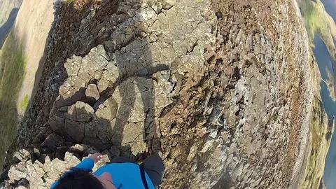 Extreme mountain walking on knife edge ridge. Birds eye view Video stock 72289949