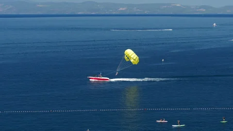 Extreme parasailing, a fun and active water sport for tourists on holiday Stock Footage 318363631